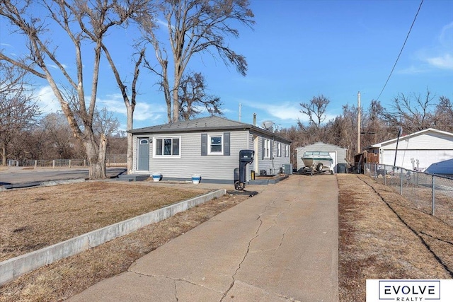 view of side of property featuring a garage and a lawn