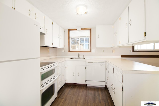kitchen with white appliances, sink, a textured ceiling, dark hardwood / wood-style flooring, and white cabinets