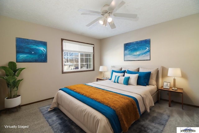 carpeted bedroom featuring ceiling fan and a textured ceiling