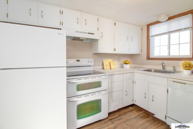 kitchen with sink, white appliances, white cabinetry, and light wood-type flooring