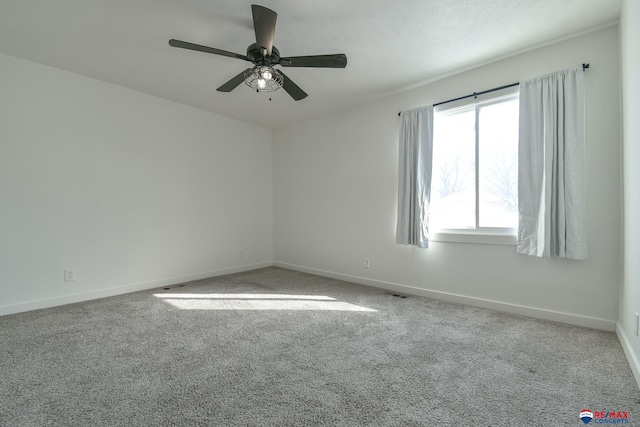 spare room featuring light carpet and ceiling fan