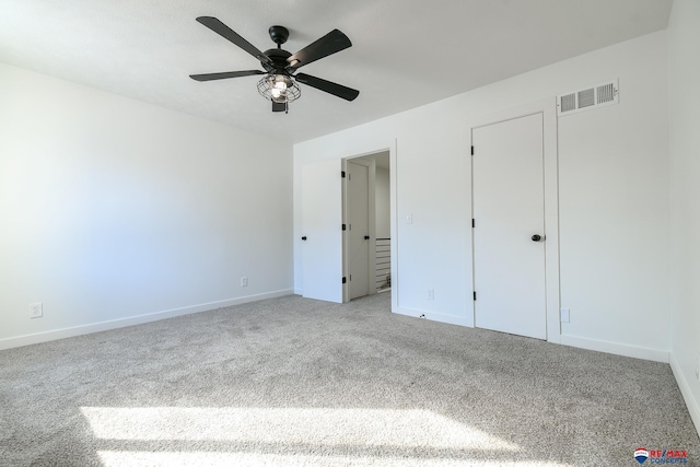 unfurnished bedroom featuring light carpet and ceiling fan