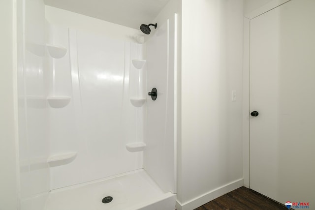 bathroom featuring walk in shower and hardwood / wood-style floors