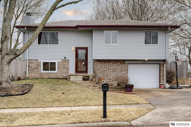 split foyer home with a garage and a front lawn