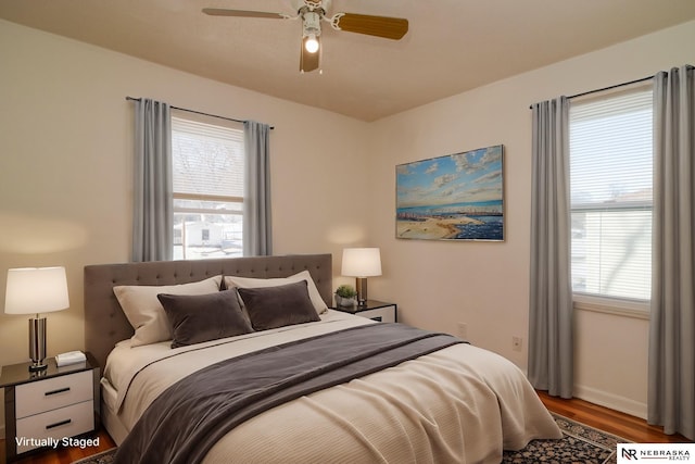 bedroom with ceiling fan and hardwood / wood-style floors