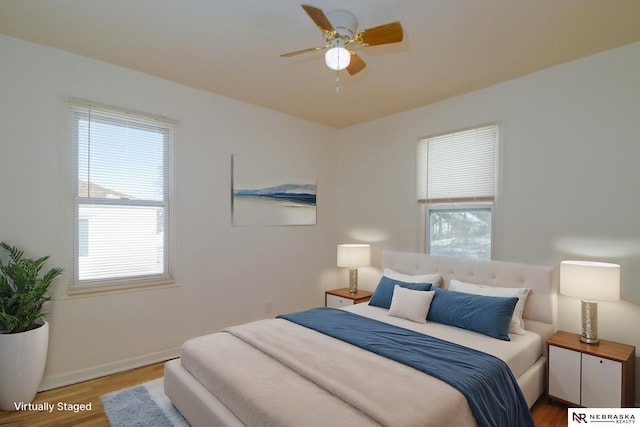 bedroom with ceiling fan and wood-type flooring