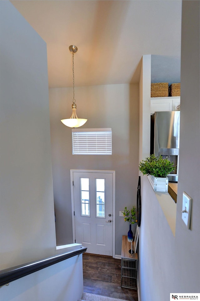 entrance foyer with dark wood-style floors and a high ceiling