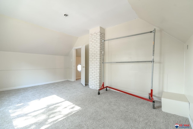 bonus room featuring light carpet and vaulted ceiling