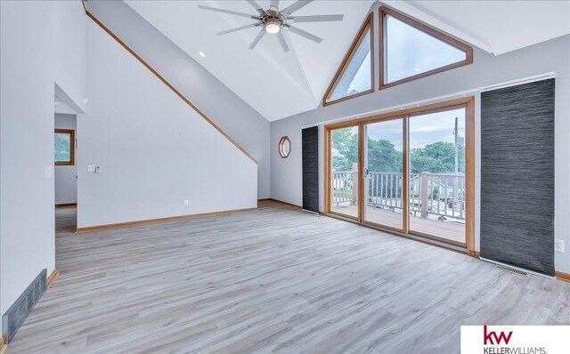 unfurnished living room with high vaulted ceiling, a ceiling fan, baseboards, and wood finished floors