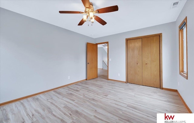 unfurnished bedroom featuring a closet, visible vents, light wood-style flooring, and baseboards