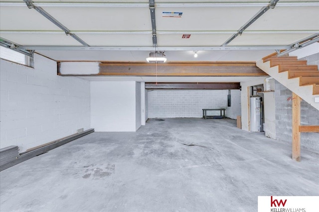 garage featuring electric water heater and a garage door opener