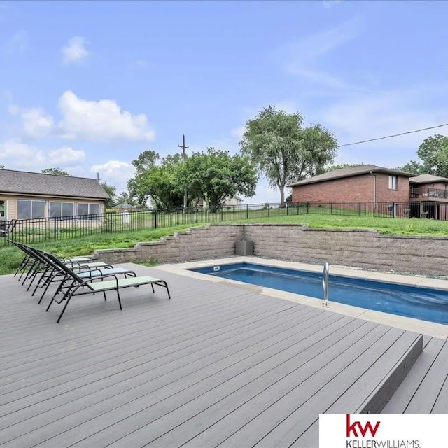 exterior space featuring a deck, a fenced backyard, and a fenced in pool