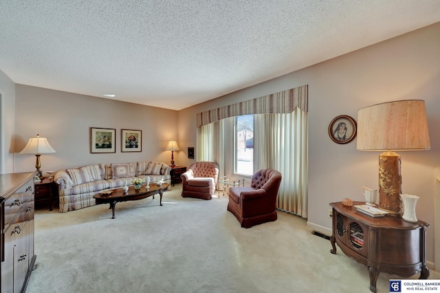 living room with a textured ceiling and light colored carpet