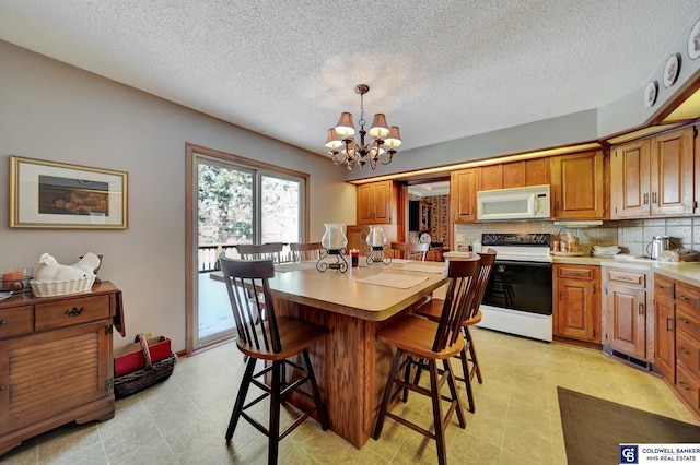 dining room with an inviting chandelier and a textured ceiling