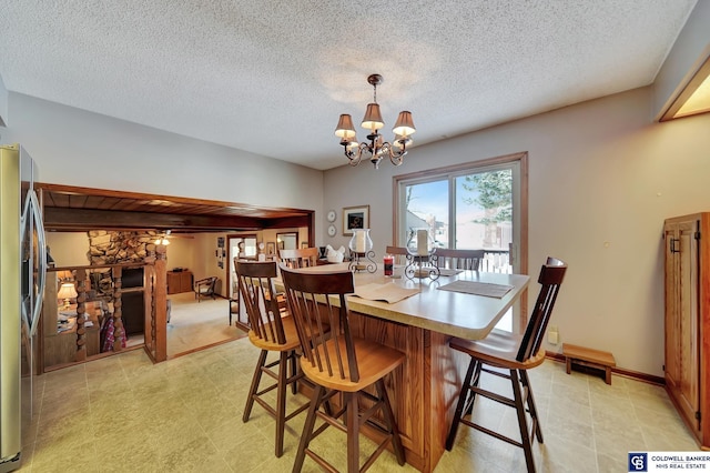 dining area featuring a chandelier and a textured ceiling