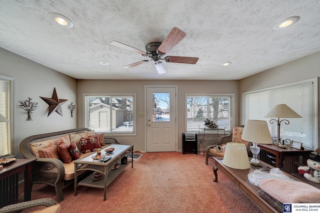 interior space with carpet, a textured ceiling, and ceiling fan