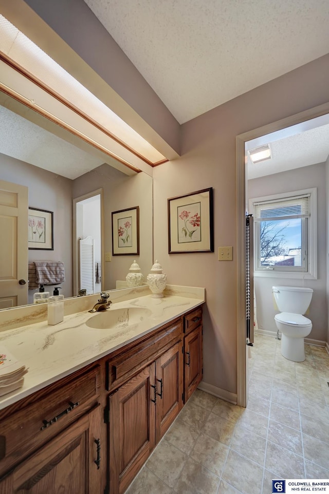 bathroom with vanity, toilet, and tile patterned floors