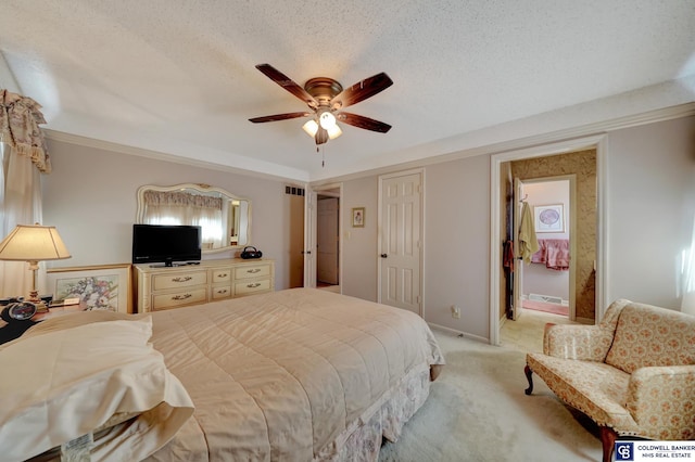 carpeted bedroom with ceiling fan and a textured ceiling