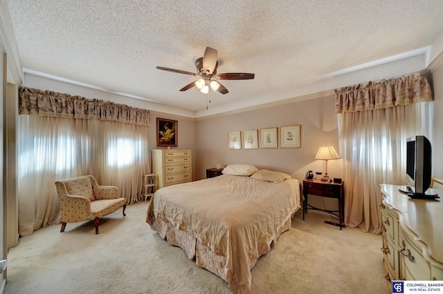 carpeted bedroom with ceiling fan and a textured ceiling