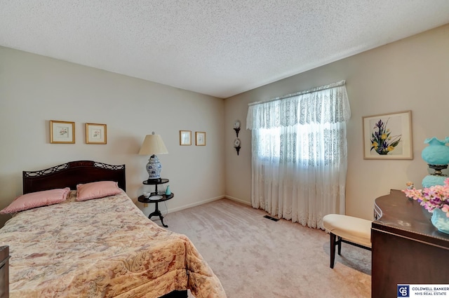 carpeted bedroom featuring a textured ceiling