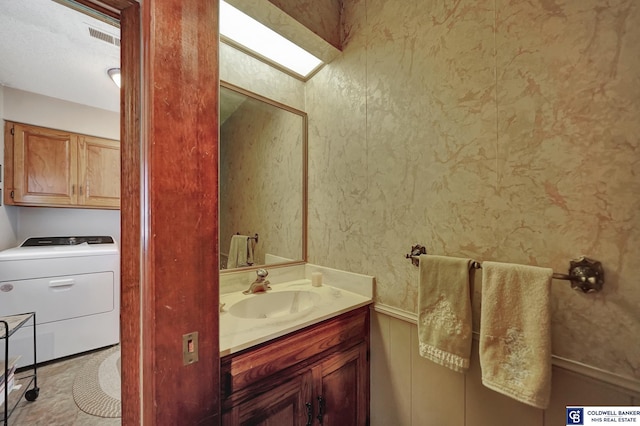 bathroom featuring washer / dryer and vanity