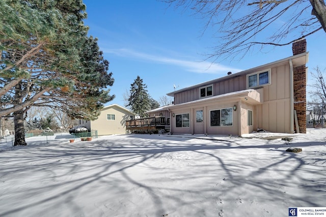 snow covered property featuring a deck