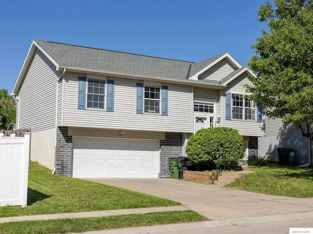7112 S 177th St, Omaha, NE 68136 - bi-level home featuring a garage, driveway, brick siding, and a shingled roof