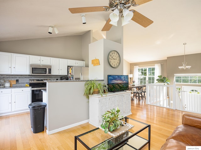 7112 S 177th St, Omaha, NE 68136 - living room featuring light wood-style floors, a ceiling fan, a chandelier, and high vaulted ceiling