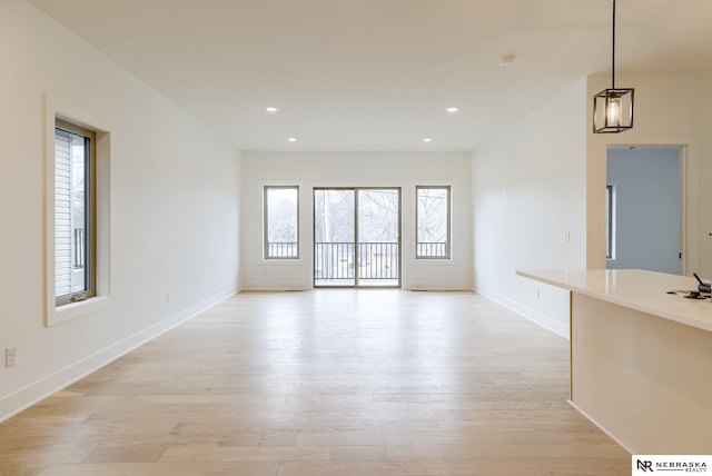 unfurnished room featuring light wood-style flooring, baseboards, and recessed lighting