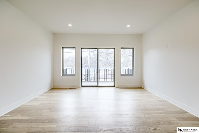 unfurnished room featuring recessed lighting, baseboards, and light wood finished floors