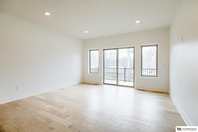 unfurnished room with recessed lighting, light wood-type flooring, and baseboards