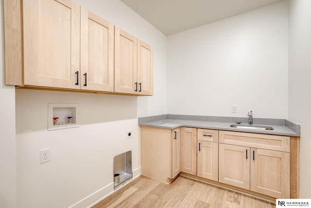 washroom with washer hookup, light wood finished floors, cabinet space, hookup for an electric dryer, and a sink