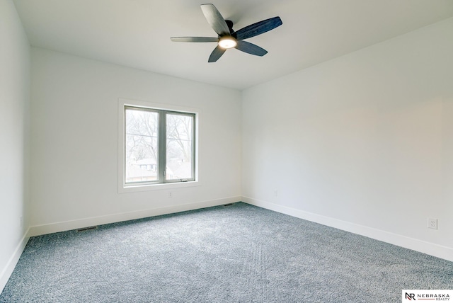 spare room featuring carpet flooring, a ceiling fan, and baseboards