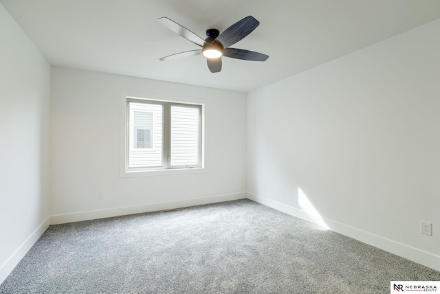 unfurnished room with carpet floors, baseboards, and a ceiling fan