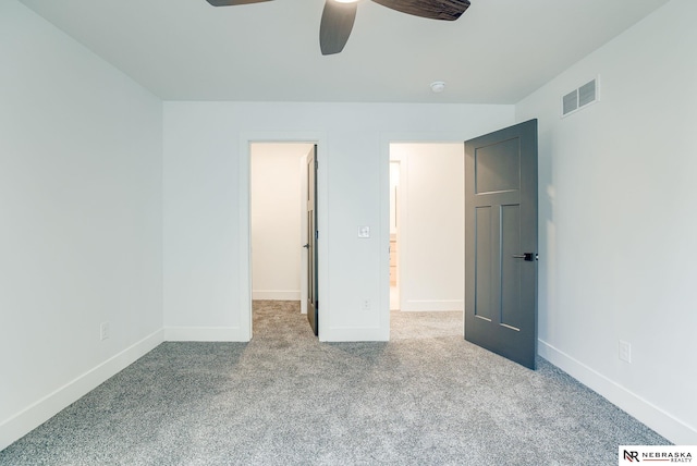 unfurnished bedroom with baseboards, visible vents, ceiling fan, and carpet flooring