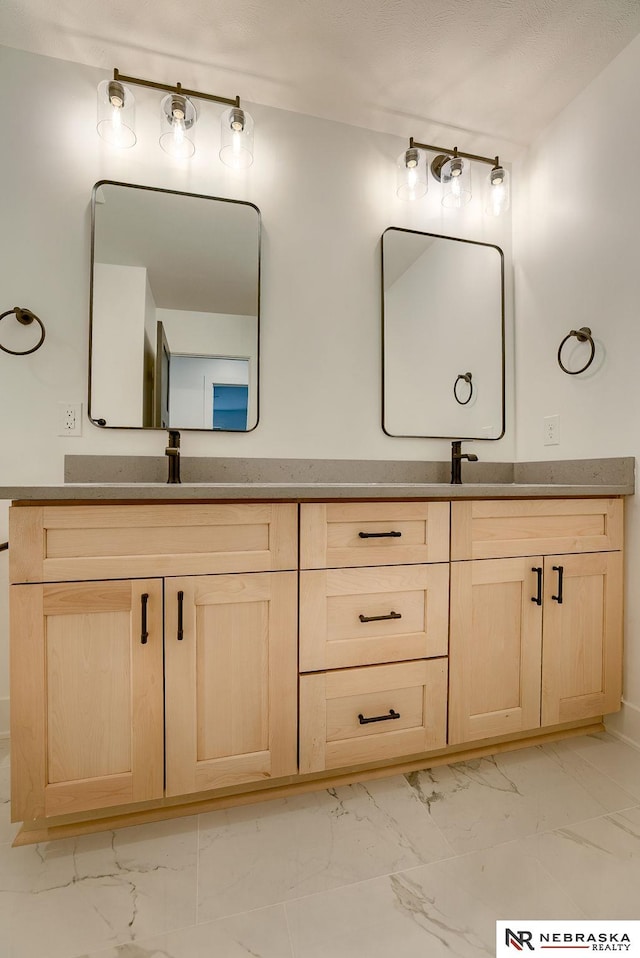 full bathroom featuring marble finish floor and double vanity