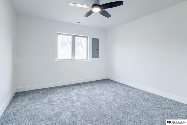 unfurnished room featuring visible vents, a ceiling fan, carpet flooring, electric panel, and baseboards