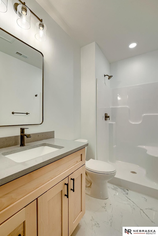 bathroom with marble finish floor, visible vents, toilet, a shower stall, and vanity