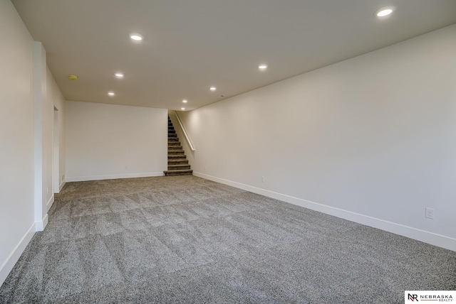 below grade area featuring recessed lighting, carpet flooring, baseboards, and stairs