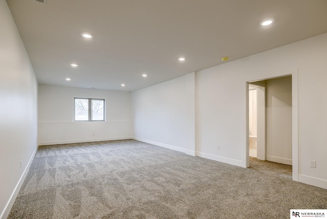 empty room featuring baseboards, carpet flooring, and recessed lighting