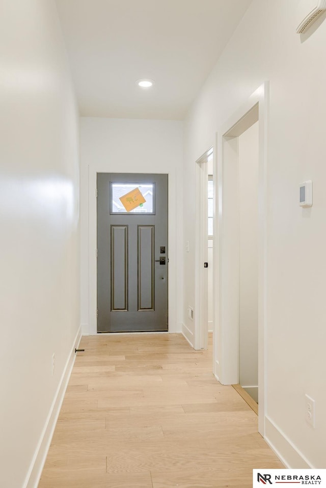 entrance foyer with recessed lighting, light wood-style flooring, and baseboards