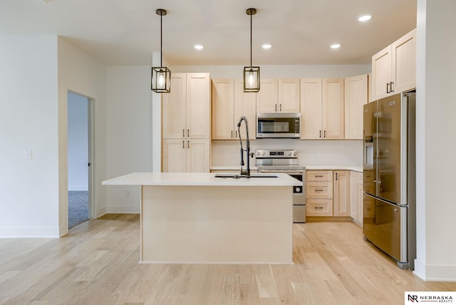 kitchen with stainless steel appliances, light countertops, light wood-type flooring, and light brown cabinets