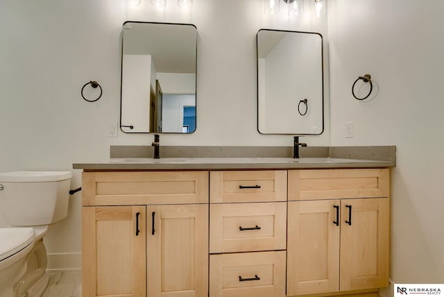 319 S 55th St, Lincoln, NE 68510 - bathroom featuring marble finish floor, a sink, toilet, and double vanity
