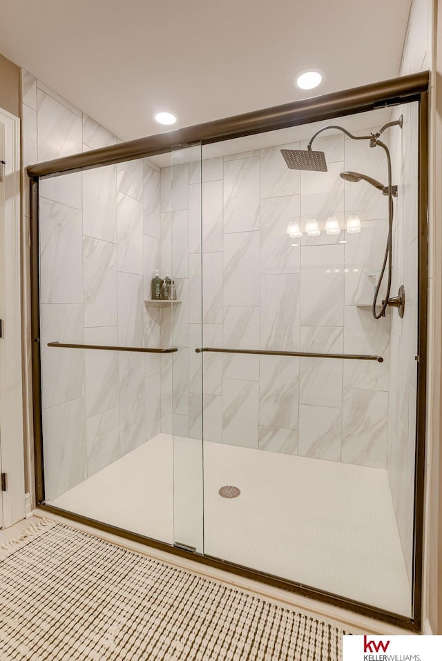 full bath with a stall shower and recessed lighting