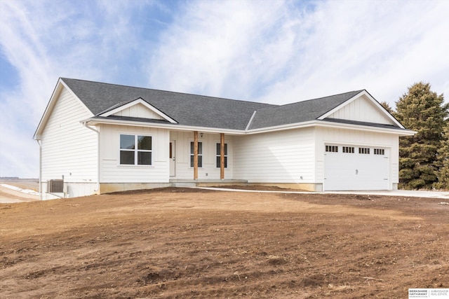 view of front of house featuring an attached garage, a porch, central AC, and roof with shingles