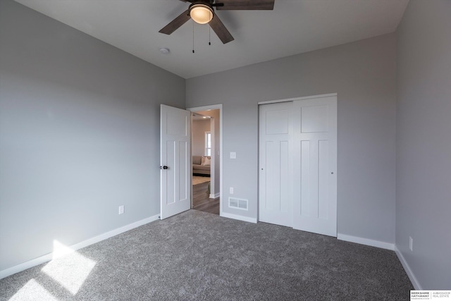 unfurnished bedroom featuring carpet, a closet, visible vents, ceiling fan, and baseboards