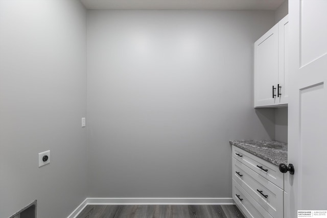 laundry room with cabinet space, baseboards, dark wood-type flooring, and electric dryer hookup