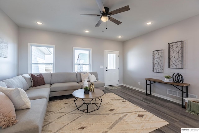 living area featuring dark wood-style flooring, plenty of natural light, visible vents, and recessed lighting