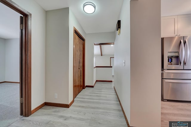 hallway with light hardwood / wood-style flooring