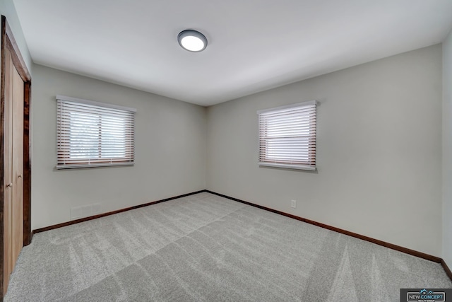 unfurnished bedroom with light colored carpet